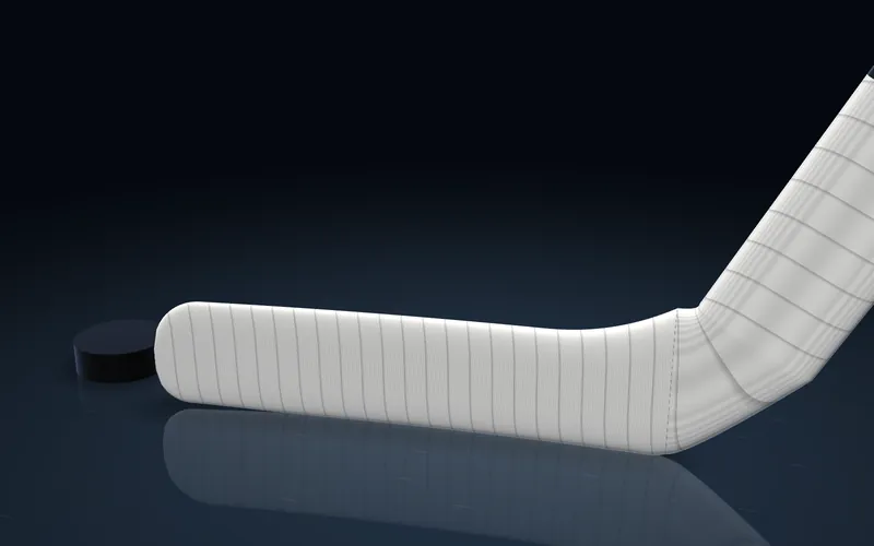 A goalie stick with white tape on the whole blade and the lower paddle, rendered in 3D.
